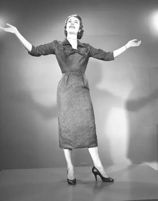 Framed Print : Woman raising hands in studio, (B&W)