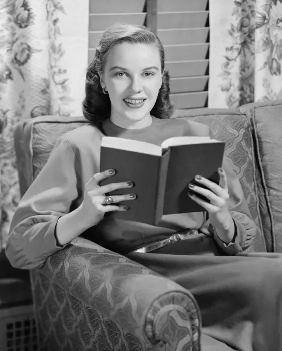 Framed Print : Woman reading book in living room, (B&W), portrait Framed Print : Woman reading book in living room, (B&W), portrait