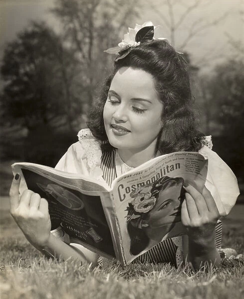 Woman reading magazine outdoors