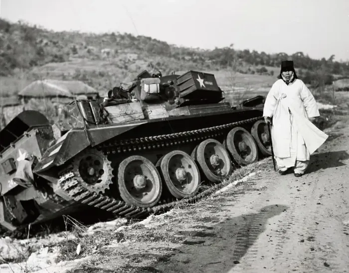 Framed Print : A Woman Refugee Walking Past A Tank Framed Print : A Woman Refugee Walking Past A Tank