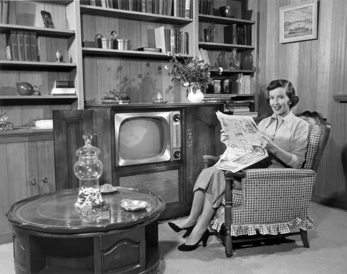 Framed Print : Woman relaxing at home with newspaper Framed Print : Woman relaxing at home with newspaper