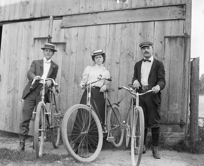 Framed Print : Woman Riding Bicycle With Two Men Framed Print : Woman Riding Bicycle With Two Men
