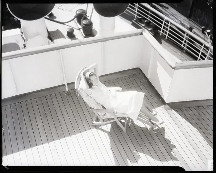 Framed Print : Woman Seated on Lounge Chair on Deck of Ship Framed Print : Woman Seated on Lounge Chair on Deck of Ship