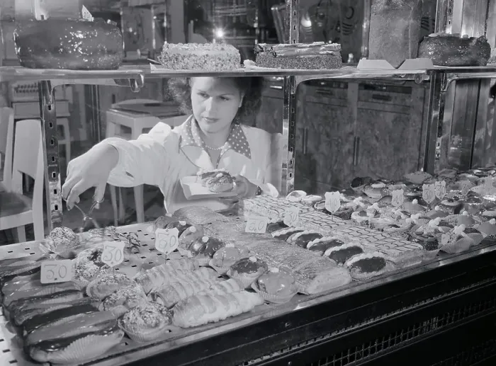 Framed Print : Woman Selecting French Pastries from Display Framed Print : Woman Selecting French Pastries from Display