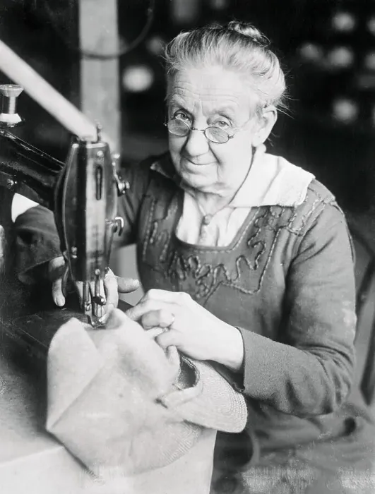Framed Print : Woman Sewing a Cap Framed Print : Woman Sewing a Cap