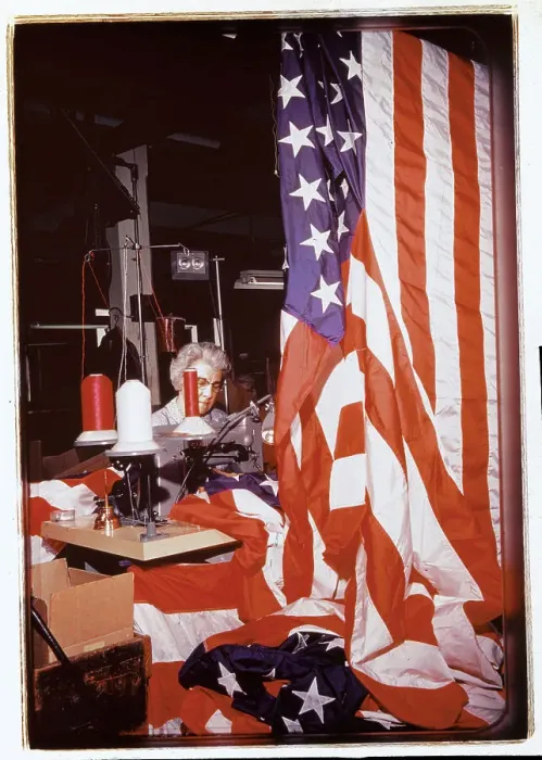 Framed Print : Woman Sewing Stripes on an American Flag Framed Print : Woman Sewing Stripes on an American Flag