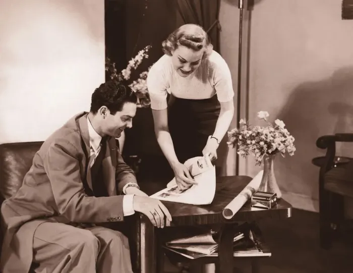 Framed Print : Woman showing brochure to man (B&W sepia tone) Framed Print : Woman showing brochure to man (B&W sepia tone)