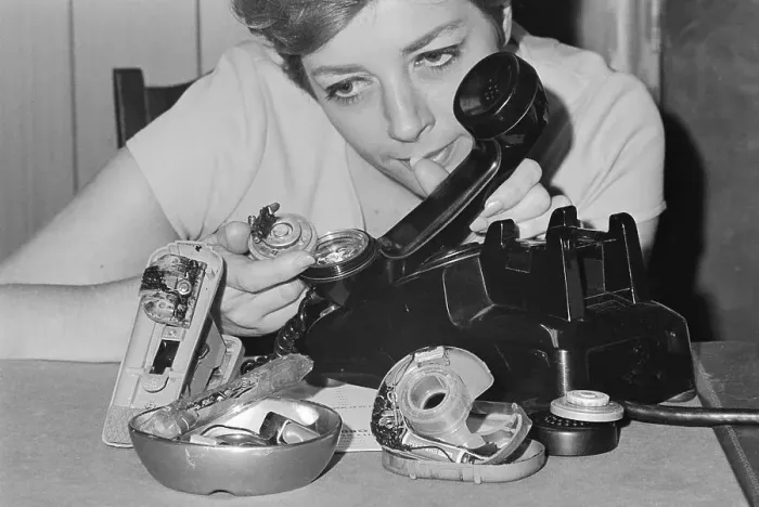 Framed Print : Woman Showing Bugged Office Equipment