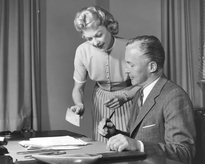 Framed Print : Woman showing man cheque, man holding pen Framed Print : Woman showing man cheque, man holding pen