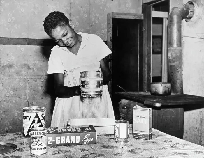 Framed Print : Woman Sifting Flour In Kitchen Framed Print : Woman Sifting Flour In Kitchen