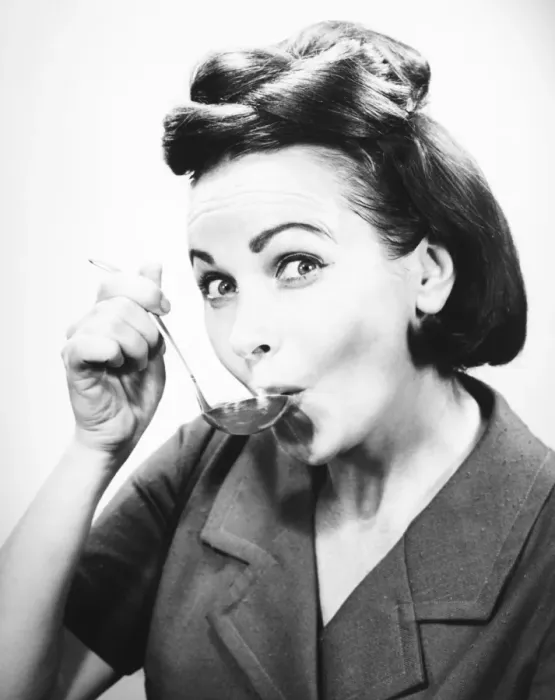 Framed Print : Woman sipping from spoon, (B&W), portrait Framed Print : Woman sipping from spoon, (B&W), portrait