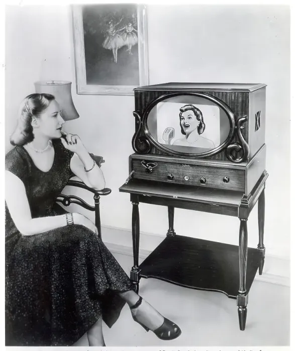Framed Print : Woman Sits And Watches Television In Ad Framed Print : Woman Sits And Watches Television In Ad
