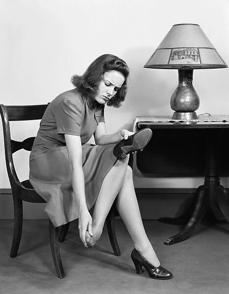 Woman sitting in chair, rubbing her feet. (Photo by H. Armstrong Roberts  /  Retrofile  /  Getty