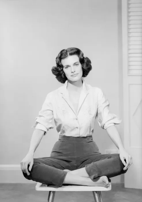Framed Print : Woman sitting crosslegged on chair, portrait Framed Print : Woman sitting crosslegged on chair, portrait