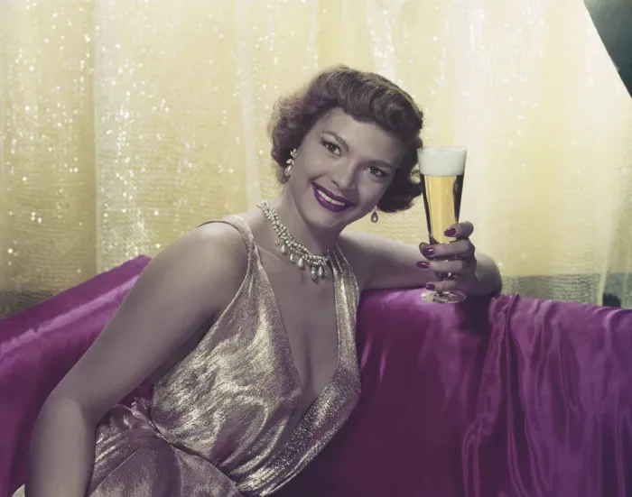 Framed Print : Woman sitting with glass of beer, portrait