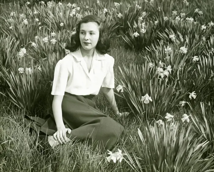 Framed Print : Woman sitting on grass among blooming daffodils, (B&W), (Portrait) Framed Print : Woman sitting on grass among blooming daffodils, (B&W), (Portrait)