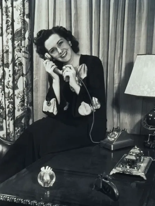 Framed Print : Woman Sitting in Lounge, Talking on Telephone Framed Print : Woman Sitting in Lounge, Talking on Telephone