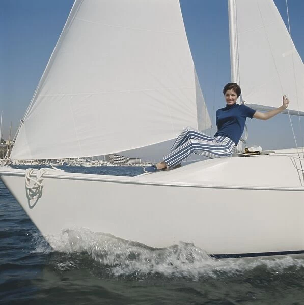 Woman sitting on sailing boat, portrait