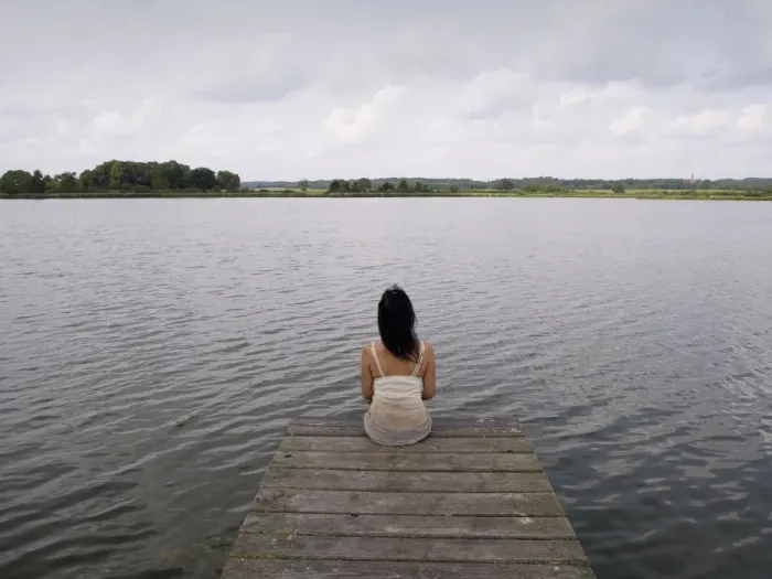 Framed Print : Woman sitting on a wooden pier at a lake, Mecklenburg Lake District, Mecklenburg-Western Pomerania, Germany, Europe Framed Print : Woman sitting on a wooden pier at a lake, Mecklenburg Lake District, Mecklenburg-Western Pomerania, Germany, Europe