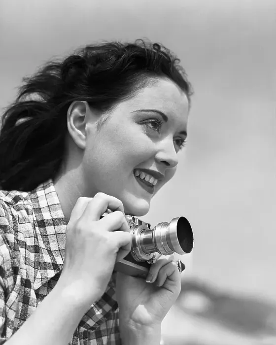 Framed Print : Woman Smiles as She Holds Camera Framed Print : Woman Smiles as She Holds Camera