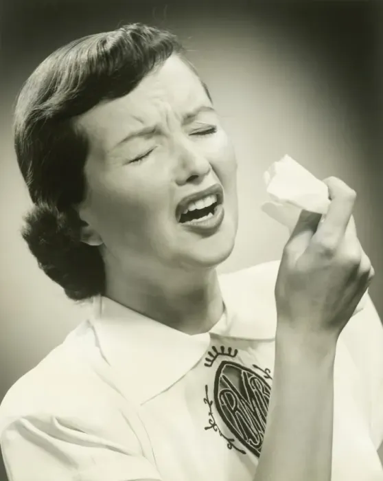 Framed Print : Woman sneezing, studio shot Framed Print : Woman sneezing, studio shot