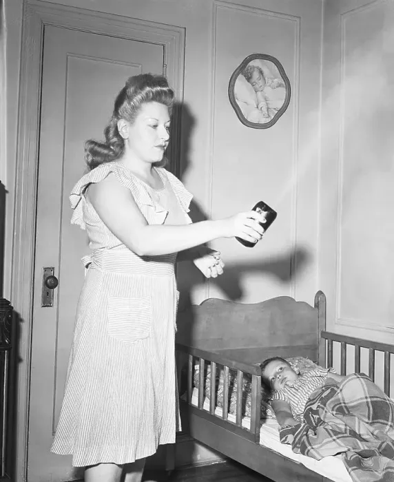 Framed Print : Woman Sprays DDT Over Her Child Framed Print : Woman Sprays DDT Over Her Child