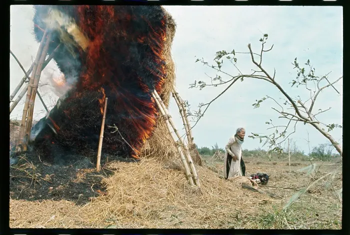 Framed Print : Woman Standing Next to a Burning Structure Framed Print : Woman Standing Next to a Burning Structure
