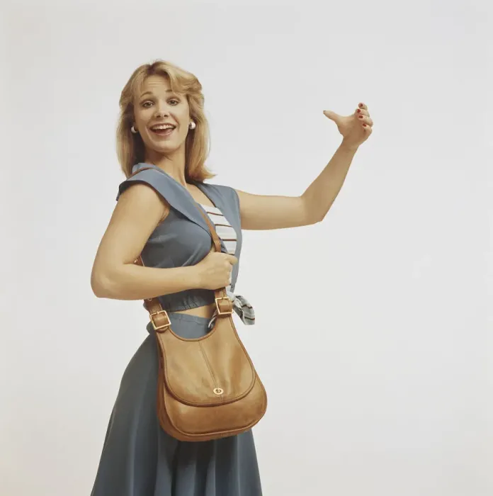 Framed Print : Woman standing with handbag and gesturing, close-up Framed Print : Woman standing with handbag and gesturing, close-up