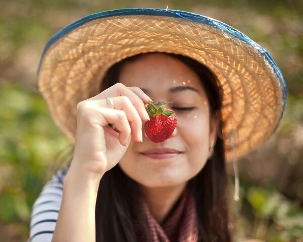 Woman with strawberry infront