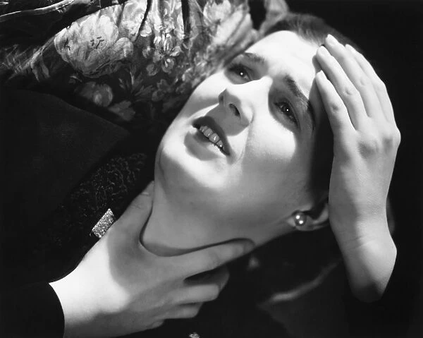 Woman suffering headache, laying in pillow, (B&W), close-up