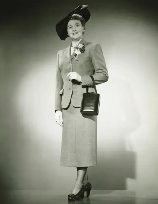 Framed Print : Woman in suit and fashionable hat standing in studio, (B&W) Framed Print : Woman in suit and fashionable hat standing in studio, (B&W)