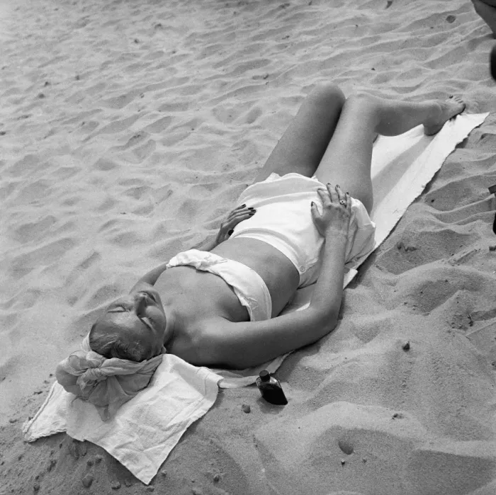 Framed Print : Woman sun tanning on beach, (B&W), elevated view Framed Print : Woman sun tanning on beach, (B&W), elevated view