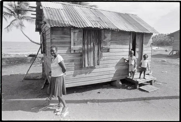 Framed Print : Woman Sweeping in Front of House Framed Print : Woman Sweeping in Front of House