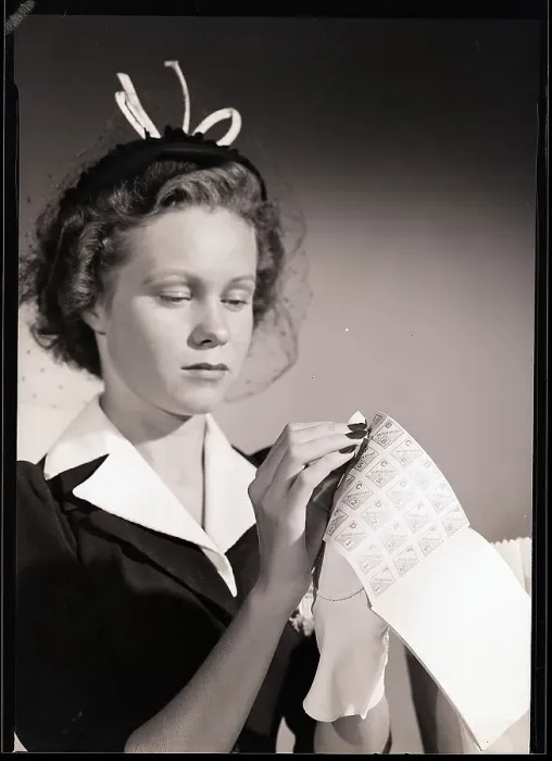 Framed Print : Woman Tearing Coupon Out Of Ration Book Framed Print : Woman Tearing Coupon Out Of Ration Book