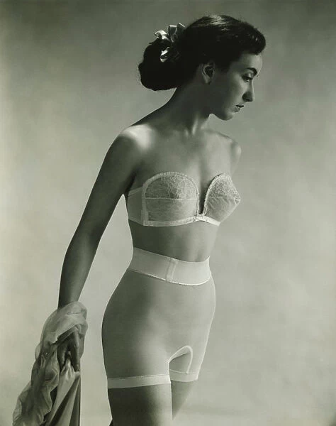 Woman in underwear posing in studio, (B&W), portrait