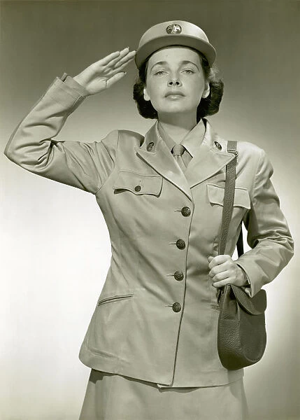 Woman in uniform saluting