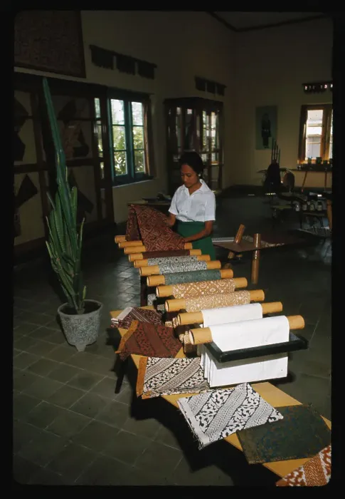 Framed Print : Woman Unrolling Batik Material