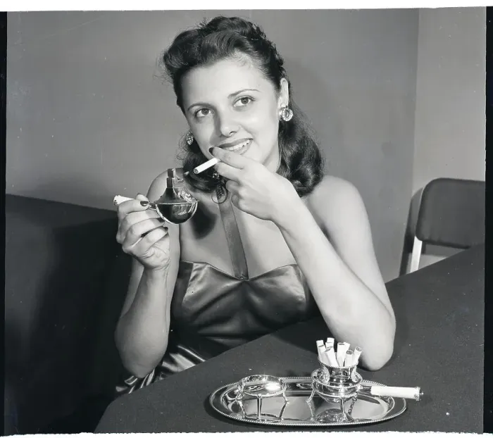 Framed Print : Woman Uses Jeweled Cigarette Lighter Framed Print : Woman Uses Jeweled Cigarette Lighter
