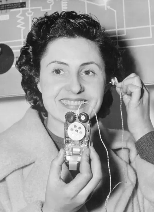 Framed Print : Woman Using Miniature Radio Receiver Framed Print : Woman Using Miniature Radio Receiver