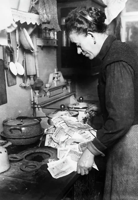 Framed Print : Woman Using Paper Money to Light Stove Framed Print : Woman Using Paper Money to Light Stove