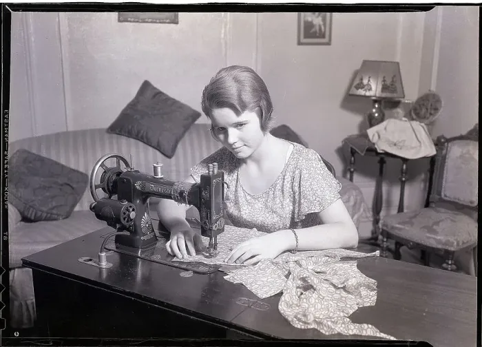 Framed Print : Woman Using a Sewing Machine Framed Print : Woman Using a Sewing Machine