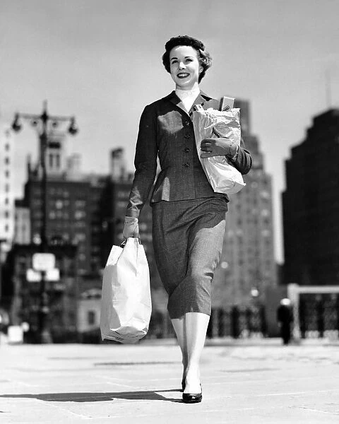 Woman walking, carrying bag