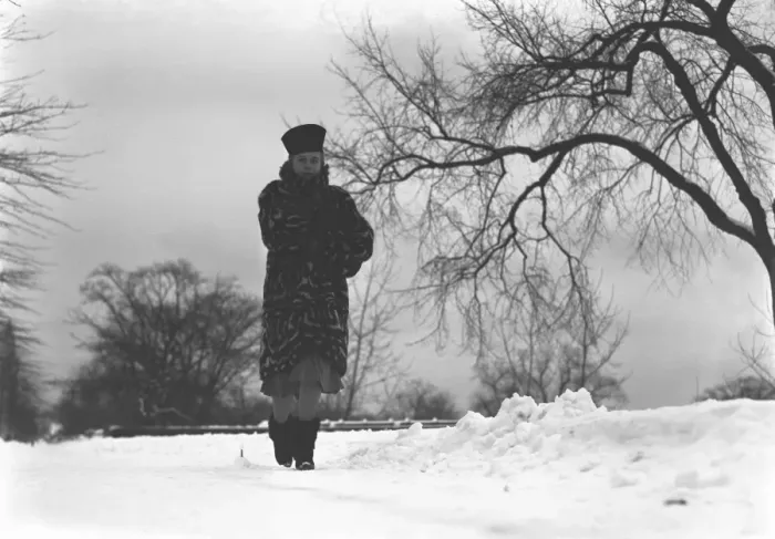 Framed Print : Woman walking on snow covered road, (B&W), low angle view Framed Print : Woman walking on snow covered road, (B&W), low angle view