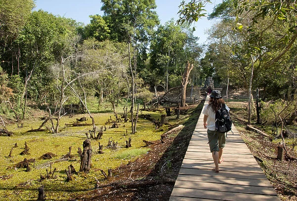 Woman on walkway at Neak Pean, Angkor, Cambodia