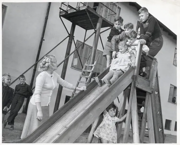 Framed Print : Woman Watching Children Play On Slide Framed Print : Woman Watching Children Play On Slide