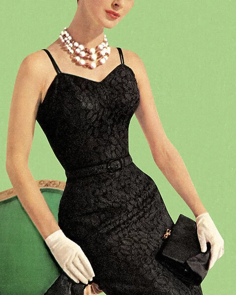 Woman wearing black dress and pearl necklace