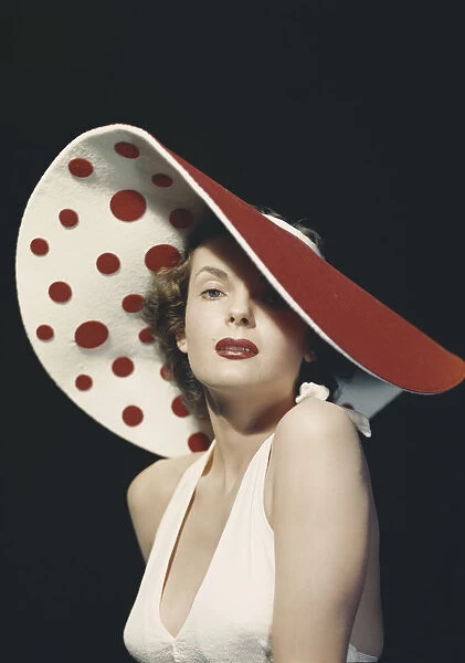 Woman wearing large spotted hat, portrait
