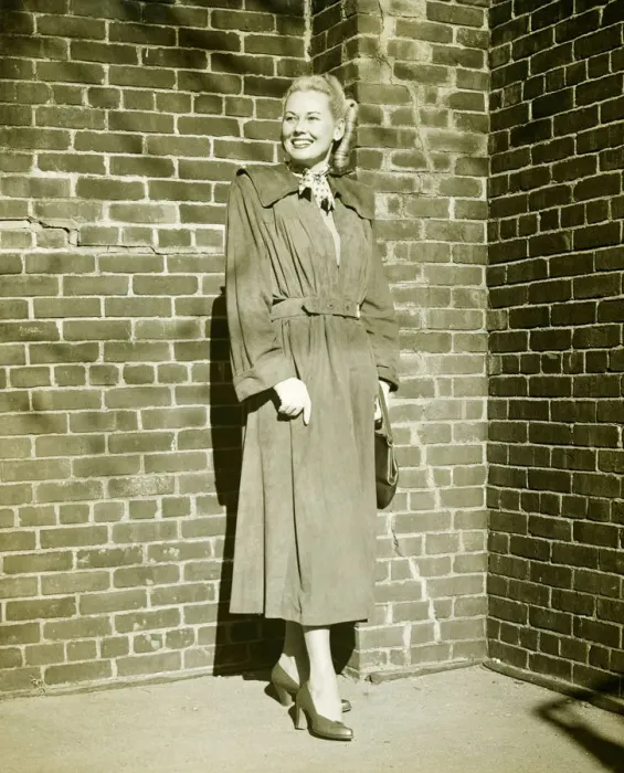 Framed Print : Woman wearing mackintosh standing at brick wall outdoors, (B&W) Framed Print : Woman wearing mackintosh standing at brick wall outdoors, (B&W)