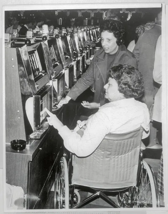 Framed Print : Woman in Wheelchair Playing Slot Machines Framed Print : Woman in Wheelchair Playing Slot Machines