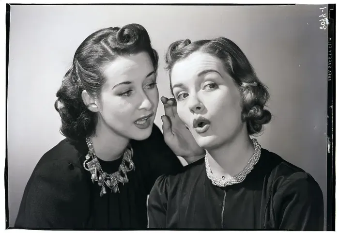 Framed Print : Woman Whispering in Friend's Ear Framed Print : Woman Whispering in Friend's Ear